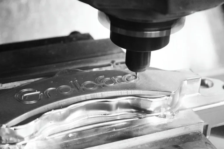 engraving the word ‘rolloface’ into a metal brake component.